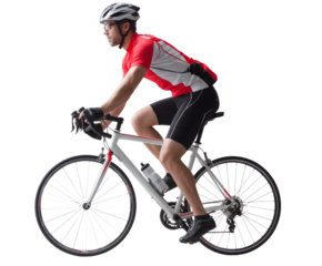 A cyclist in action, pedaling hard on a road bike during an outdoor ride.