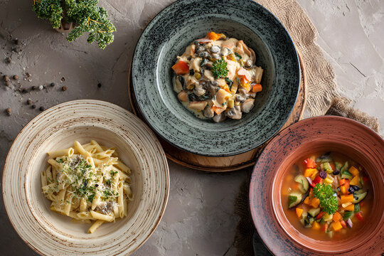 Three Course Meal: Pasta, Creamy Vegetables, and Soup Displayed Artistically