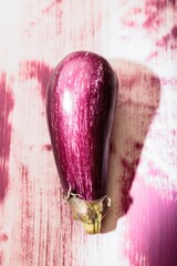 An eye-catching eggplant artwork adorns a wall in the heart of a city, showcasing colorful graffiti techniques