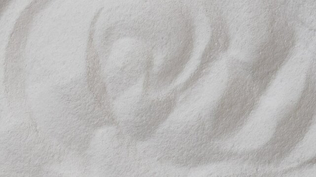 rotating pile of fine collagen powder on white surface in soft swirl pattern, concept of beauty supplement, skin and joint health, wellness nutrition product presentation