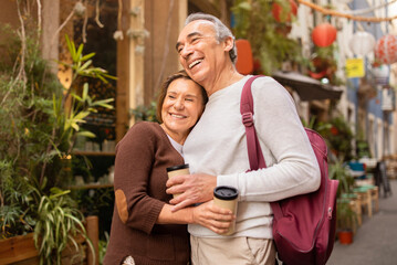 Happy Vacation Travel. Cheerful Mature Spouses Enjoying Their Lisbon Getaway, Hugging Posing With...