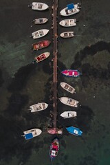 Aerial view of a docked boats arrangement in a serene harbor.