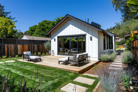 Professional photo of a single-level ADU with modern farmhouse style, frontal elevation view, showcasing the backyard in Marin County, California...