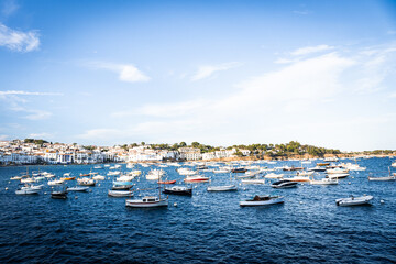 Obraz premium View of Cadaques, charming town in Catalonia, Spain. Mediterranean city on a bay with boats floating