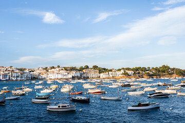 Fototapeta premium View of Cadaques, charming town in Catalonia, Spain. Mediterranean city on a bay with boats floating