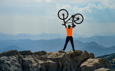 The success of a person who reached the summit of a mystical and high mountain range with his bike