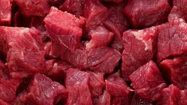 raw beef cubes turning in slow rotation, showcasing rich red color and natural texture, ideal for food preparation visuals, recipes, and protein nutrition themes