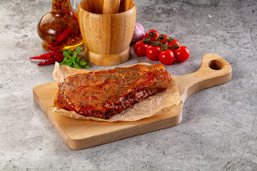 Raw marinated pork loin steak