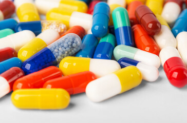 many colored pills close-up red, blue, yellow
