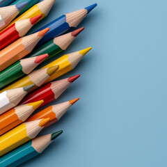 Colorful pencils arranged neatly on blue background
