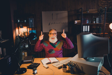 Elderly Bearded Man Enthusiastically Working on Technology Concepts in Cozy Home Office with Dim...