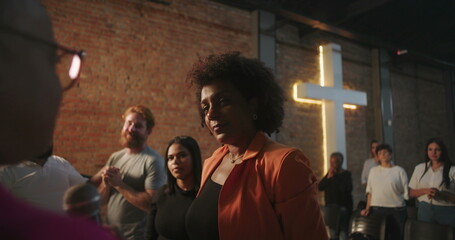 Congregation members embracing during a Christian event, sharing a moment of spiritual connection with love and support