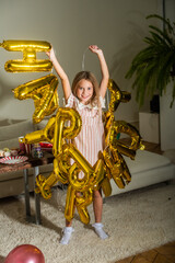 girl preparing for birthday party. teenager decorating room. balloon garland. holiday and happiness
