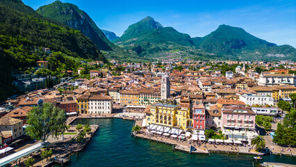 Aerial view of Riva del Garda with Torre Apponale, MAG museum, bike paths, boats and river ferries...