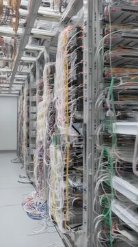 Complex cabling network in a server room featuring colorful wires and sophisticated equipment for advanced data processing and connectivity.