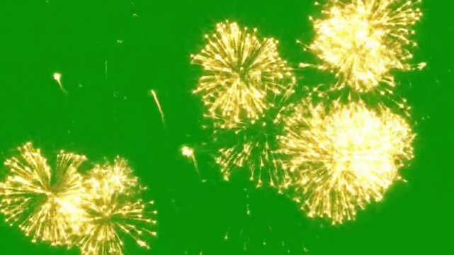 Golden fireworks exploding on a green screen background for compositing