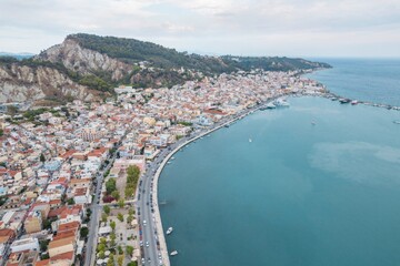 Bustling Zakynthos welcomes visitors with its picturesque waterfront, charming architecture, and vibrant tourist activities under a summer sky, inviting exploration and relaxation