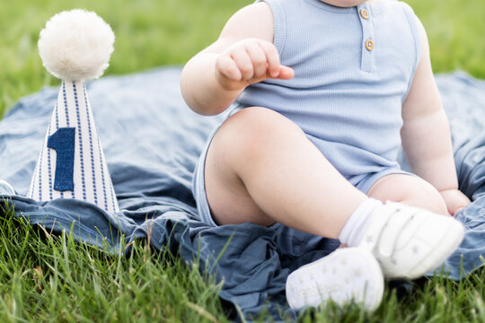Closeup of one year old  birthday boy and party hat 