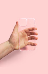 Clean transparent phone case displayed in hand against light pink backdrop, Modern and comfortable design