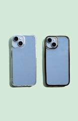 Transparent phone cases, one clean and one dirty, displayed side by side on light green background, demonstrating contrast in appearance visual appearance