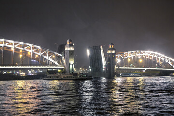 The Bridge of Peter the Great. Bridge in St. Petersburg. Bolsheokhtinsky Bridge. Drawbridge. Bolsheokhtinsky bridge in St. Petersburg at night with open spans over the Neva.