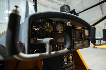 Dashboard yellow airplane glider in hangar. 