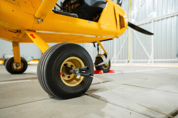 Close-Up of a Yellow Aircraft Wheel in Hangar