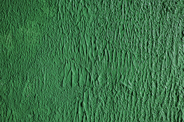 Close-up texture of rough green plaster.