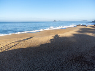 Amazing lighting on orange sand beach and strong waves in coastal village