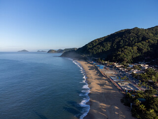Amazing lighting on orange sand beach and strong waves in coastal village