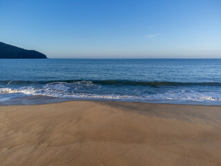 Beautiful orange sand beach and ocean horizon at dawn