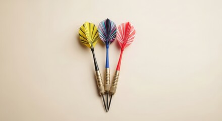 Three colorful darts with yellow, blue, and red flights. Professional sport equipment for competition and target board.