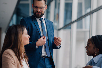 Businessman explaining strategy to colleagues in modern office