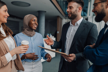 Diverse business team discussing work in modern office building