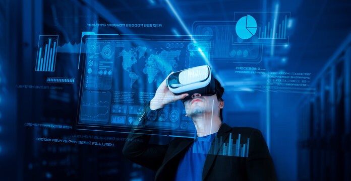 Businessman with headset standing at data center while analyzing financial data. Manager looking marketing statistic hologram and using augmented reality goggles while making a decision. Ingenuity.