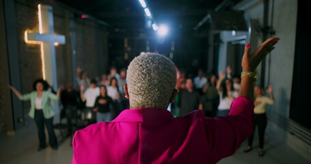 Church service with pastor leading praise and prayer, congregation actively participating with...