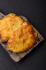 Steak, a pork or chicken chop covered with melted cheese. Grilled meat