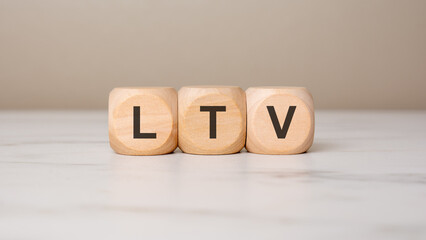 Wooden blocks with LTV letters on a light background