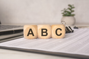 ABC wooden blocks on documents with business office background