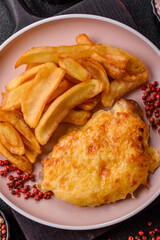 Fried French fries with a piece of meat, lunch food. Prepared potatoes and meat