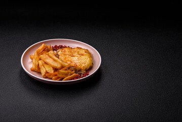 Fried French fries with a piece of meat, lunch food. Prepared potatoes and meat