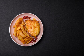 Fried French fries with a piece of meat, lunch food. Prepared potatoes and meat
