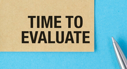 A pen is on a piece of paper with the words Time to Evaluate written on it