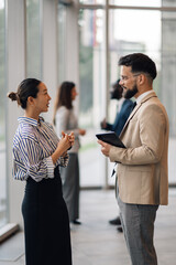 Businesspeople discussing work in modern office building