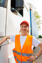 Portrait young adult happy smiling woman heavy truck driver modern cargo vehicle cabin background. Female person girl professional job career working driving freight engine lorry. Logistics industry