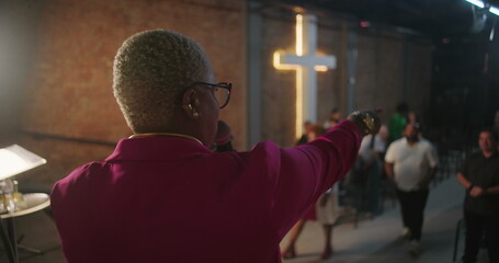 Pastor calling participants from the audience during church service, spiritual moment of...
