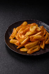 Fried crispy French fries with salt, spices, food for lunch