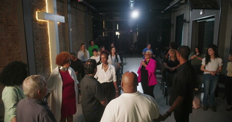Congregation participating in prayer and worship, focused on spiritual connection, leader guiding service in modern evangelical church setting