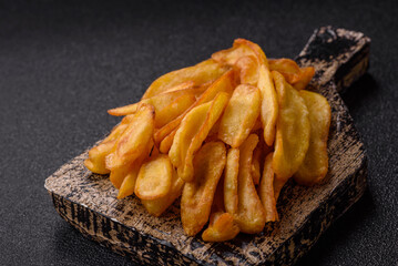 Fried crispy French fries with salt, spices, food for lunch