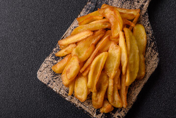 Fried crispy French fries with salt, spices, food for lunch